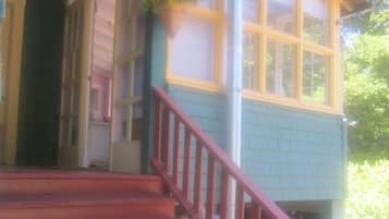 A staircase leading to a house with a red railing.