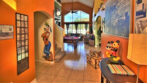 A spacious living area with a pool table, a sofa, and a Mickey Mouse statue. - Adventure Villa - Heated Pool & Spa - Themed Rooms - Min. to Disney - Game room (Davenport)