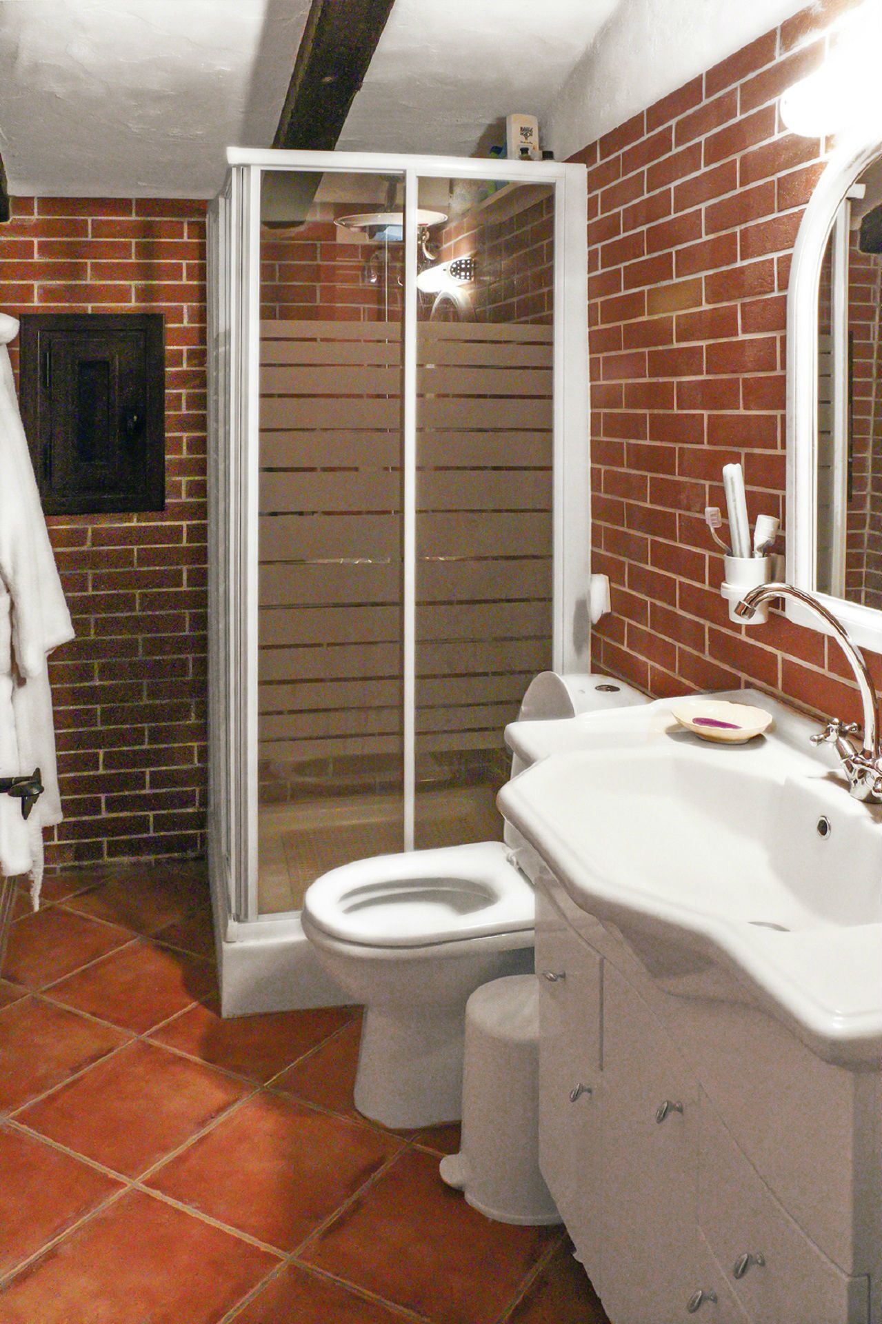 A bathroom with a shower, toilet, and sink.