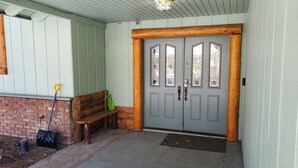A wooden bench, a broom, and a shovel outside a door with a window. - Expansive Lake View Home1 mile from the Village w/ Hot tub & Game Rm VRR20250487 (Big Bear Lake)