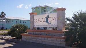 A sign for Coral Cay Beachfront Condominiums.