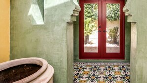 A doorway with a red door, a tiled floor, and a green wall. - MOROCCAN POOL/SPA VILLA IN PALM SPRINGS GREAT DEEPWELL NEIGHBORHOOD
PS ID106 (Palm Springs)