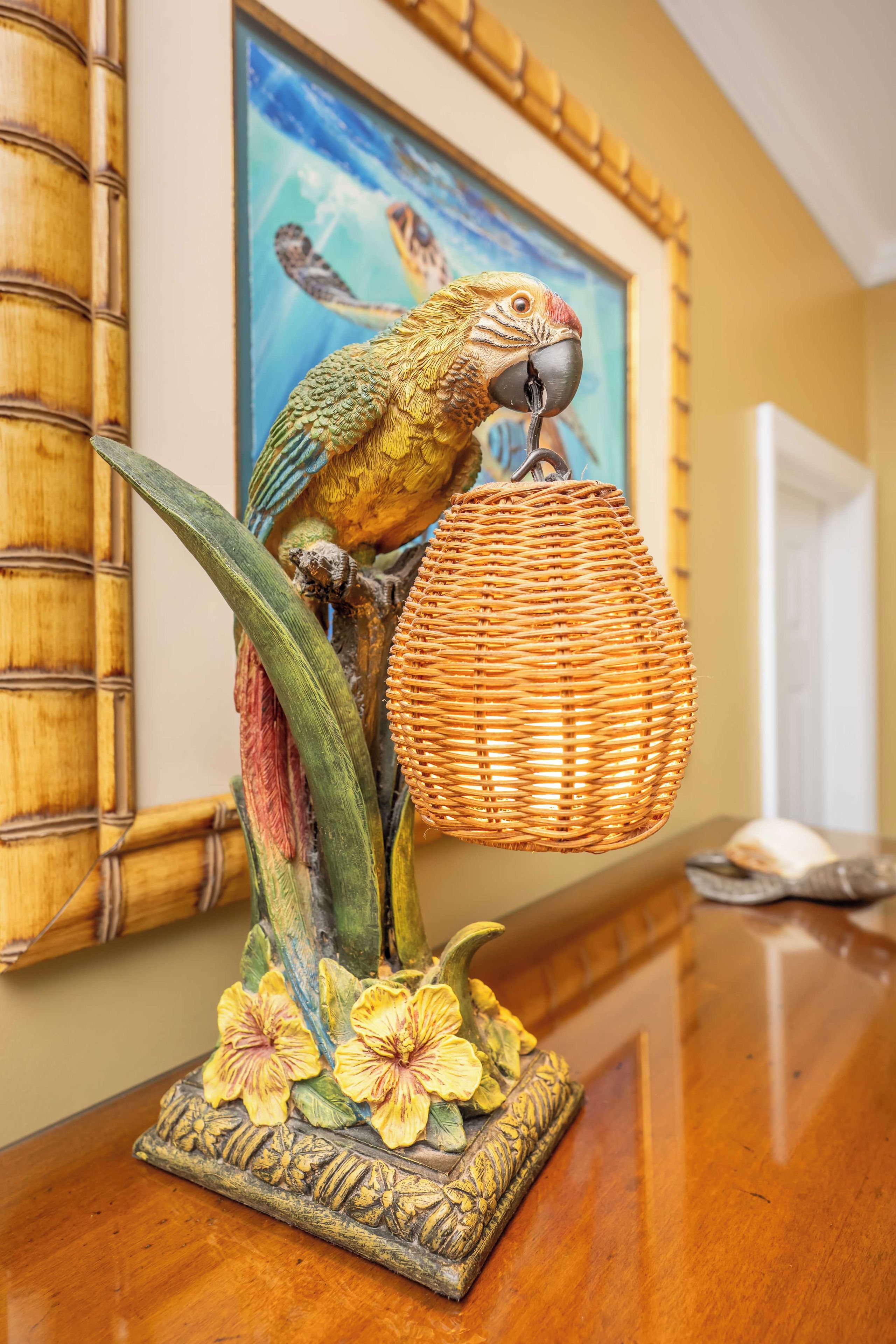 A decorative bird sculpture with a woven basket on a table.