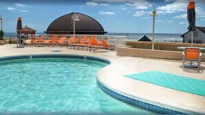 A pool area with lounge chairs and a dome structure. - DIRECT Oceanfront on Boardwalk — Thanksgiving — Nov 23-27 — 2, 3 or 4 nights (Atlantic City)