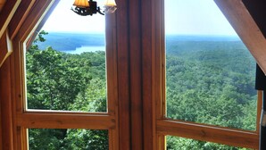 A wooden cabin with large windows offering a view of a forested landscape. - Mountain top overlooking lake, Hot Tub, Pickleball, Yukon Fire Pit, 5 STAR, PETS (Waleska)