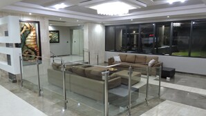 A modern lobby with a glass partition, a sofa, and a large window. - New Oceanfront Dream apartment on the beach of Isla Verde! (Carolina)