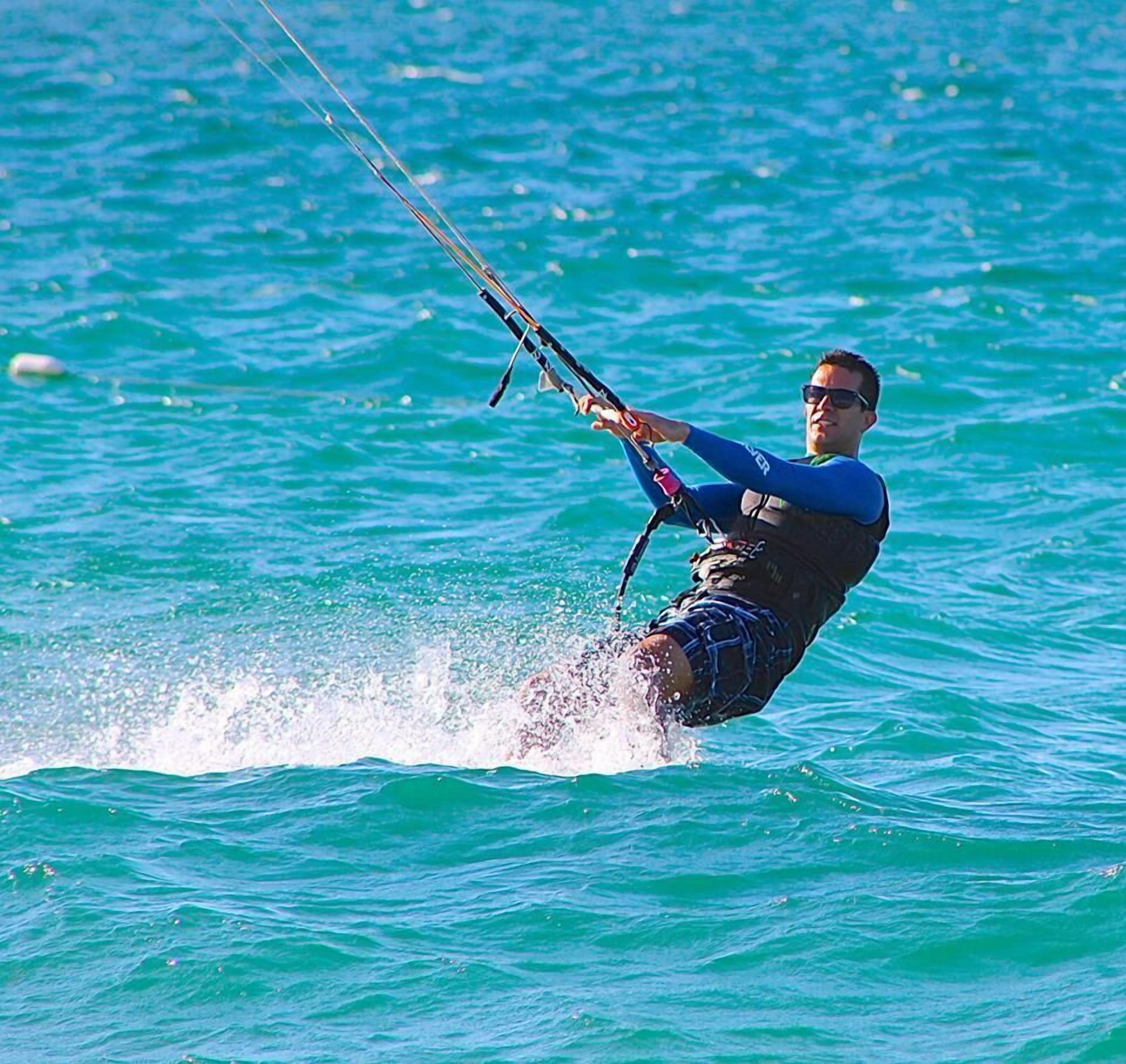 A person windsurfing in a body of water.