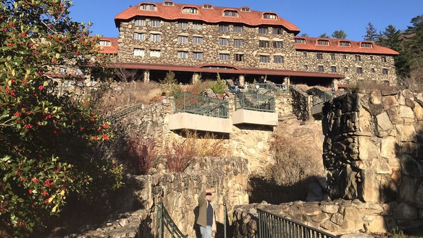 A stone building with multiple windows and balconies, featuring a stone facade and red roof. - Sweet Cabin in the Woods -10 min to Ashvl., Quiet, BEES , Garden & DECK. Dogs Ok (Asheville)