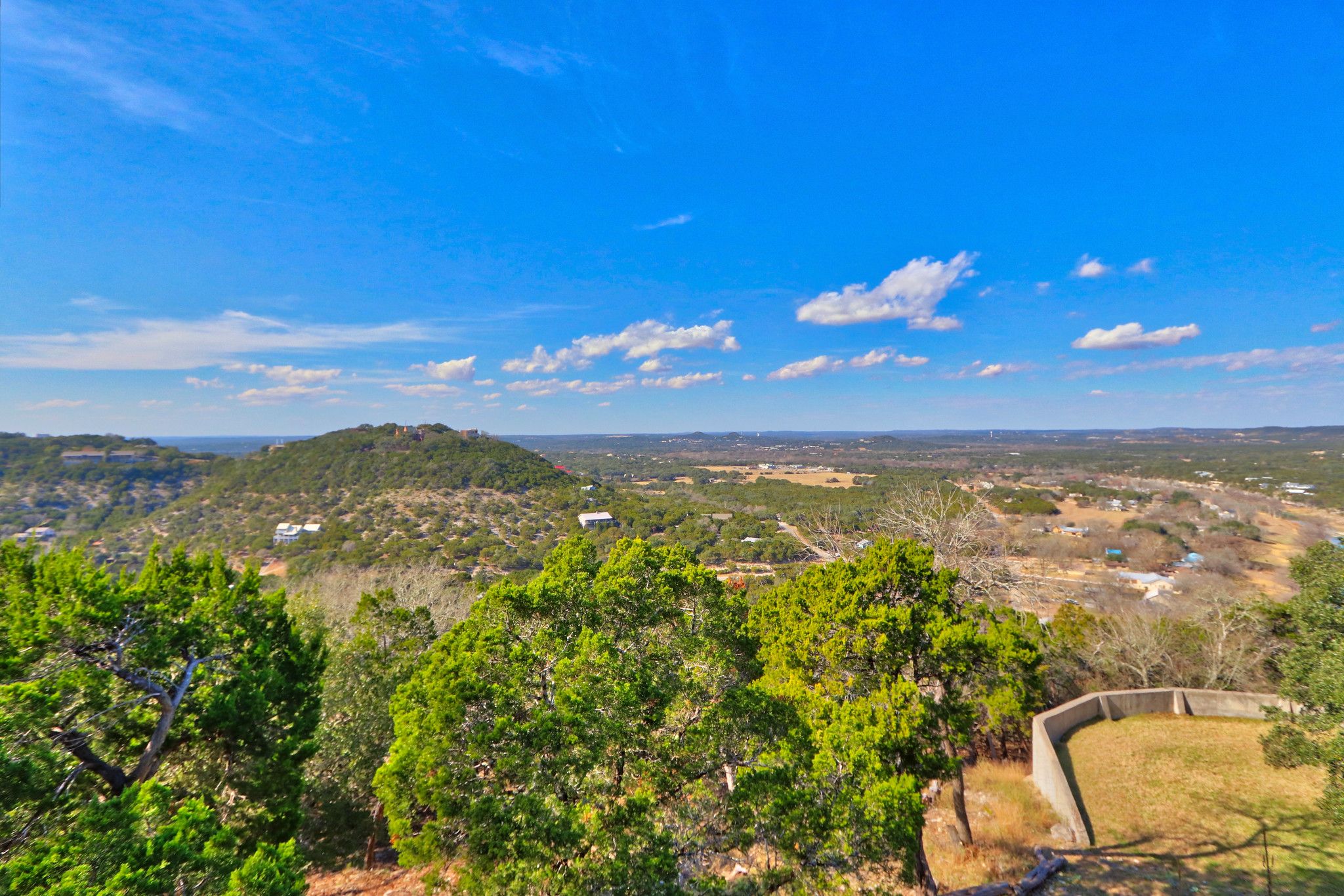 A panoramic view of a hilly landscape with a clear sky.