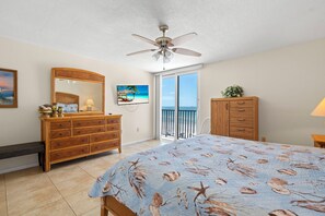 A bedroom with a bed, dresser, mirror, and a ceiling fan. - Special Rates for Nov 21 - Dec 19, 2026 - All Rooms Directly Beach Front (Madeira Beach)