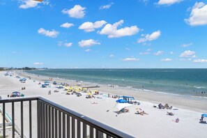 A beach with umbrellas and people. - Special Rates for Dec 05-26, 2026 - All Rooms Directly Beach Front (Madeira Beach)
