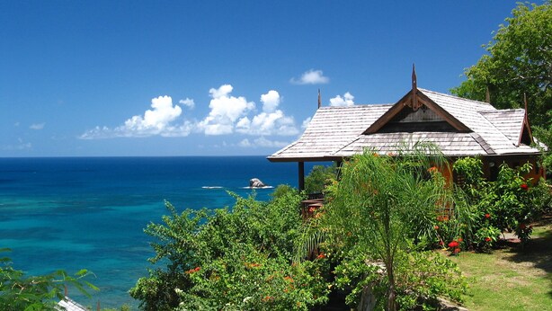 A wooden structure with a peaked roof overlooking a clear blue sea and lush greenery. - Ti Zan: Views to Die For. Perfect for two (Gros Islet)