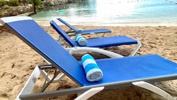 On the beach, sun loungers, beach towels