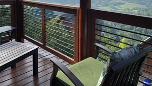 A wooden deck with a view of distant mountains and a clear sky. - Couples Dream Getaway! Unobstructed Views of the Smoky Mountains National Park! (Sevierville)