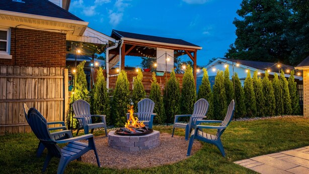 A backyard with a fire pit, outdoor seating, and string lights. - 5BR w/ 6 King Beds + Hot Tub (Louisville)