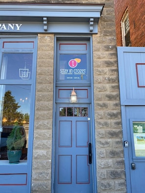 A blue door with a keyhole and a sign for 'Stay in Crozet' overnight lodging.