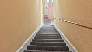 A staircase with a wooden star decoration, a green star, and an EXIT sign. - Stay in Crozet Mountain Suite in Downtown Crozet (Crozet)
