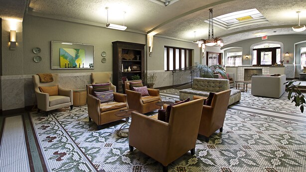 A spacious lobby with a high ceiling, skylights, and a patterned floor.