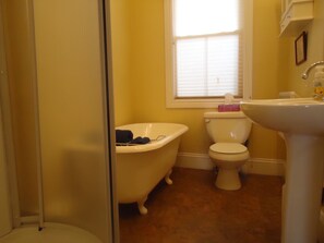 Bathroom features a clawfoot bathtub, toilet, and sink.