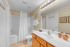 A bathroom with a shower, toilet, vanity, and a large mirror. - Ariel Dunes - Amazing Gulf Views, Pools, Gym, Walk to Beach, On-Site Dining.  😎 (Miramar Beach)