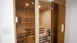 Un espai de sauna amb seients de fusta i un panell de control.