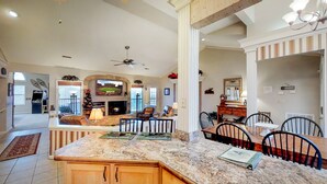 A spacious living area with a fireplace, comfortable seating, and a television.