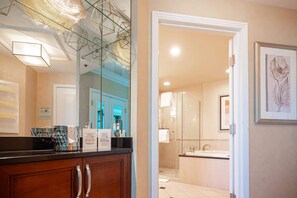 A modern bathroom with a glass shower enclosure, a sink, and a large mirror. - No Resort Fee Strip View Suite+ Free Valet + Pool (Las Vegas)
