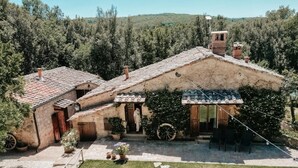 Eine rustikale Villa mit Ziegeldach, Steinofen und gepflastertem Innenhof.