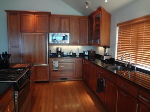 Enjoy cooking in this well-equipped kitchen with a refrigerator, microwave, and stove.