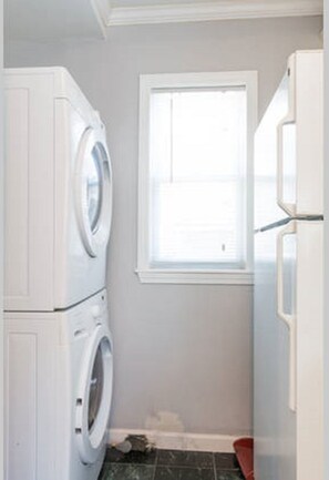 Compact laundry room with a washer and dryer, offering convenient access to natural light.