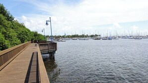 A wooden pier extending into calm water with boats docked in the background. - City&Ocean View Balcony. Pool & Hottub. Fast Wi-Fi (Miami)
