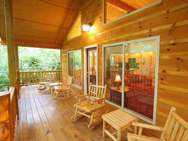 A wooden cabin with a porch, rocking chairs, and large windows. - Helen Riverside Cabin-Chattahoochee River-Walk to Town (Helen)