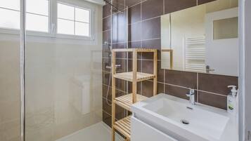 Shower, hair dryer, soap, toilet paper