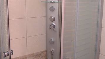 Shower, hair dryer, towels, toilet paper