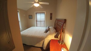 A bedroom with a bed, a nightstand, a lamp, a ceiling fan, and a window with blinds. - A short walk everywhere.  Great Fall and Spring Rates (Ogunquit)
