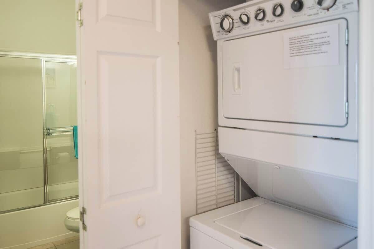 A laundry room with a washer and dryer stacked on top of each other.