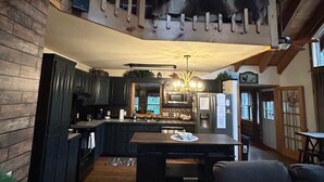 A spacious loft-style living area with a kitchen, a dining table, and a sofa.