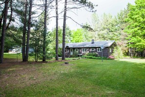 A house surrounded by trees with a grassy yard. - Hiawatha’s Hideaway Northwoods Cabin Near Pictured Rocks & Area Lakes (Wetmore)