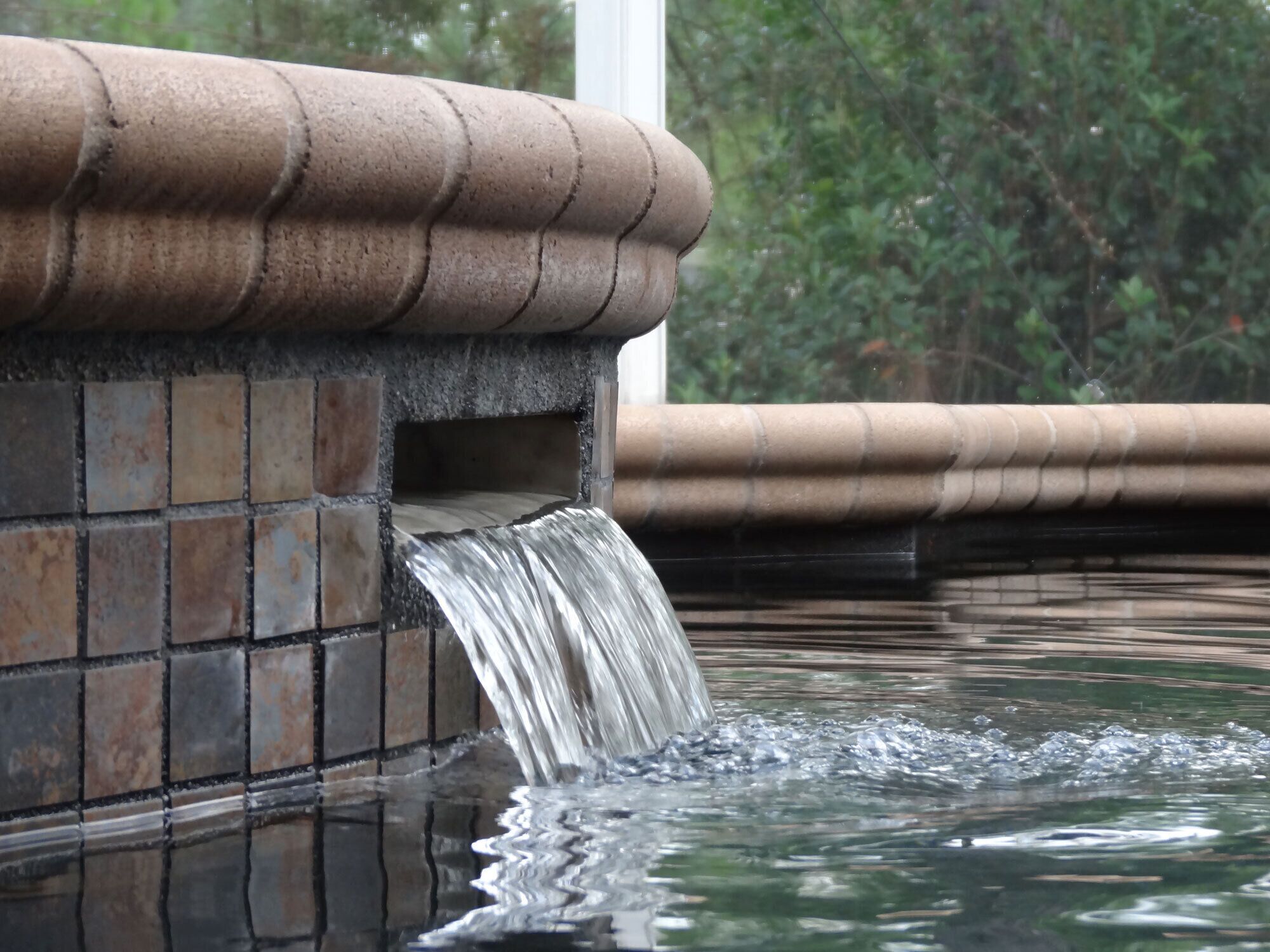 A water feature with a brick structure and a flowing stream.