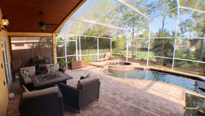 A covered patio area with outdoor furniture, a fire pit, and a swimming pool. - ☀️ Outstandning & Lavish Luxury Villa ☀️ Private Pool & Spa & Golf Course View ⛳ (Haines City)