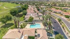 A residential area with houses, a swimming pool, and a road. - Completely Renovated PGA West - Stadium Course -  Lic #259026 (La Quinta)