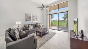 A modern living room with a grey sofa set, a coffee table, and a flat-screen TV. - Completely Renovated PGA West - Stadium Course -  Lic #259026 (La Quinta)