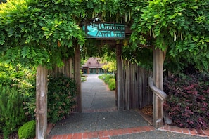A wooden archway with a sign reading "The Botanical Garden."