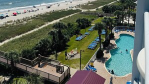 A resort with a beach view, a swimming pool, and a deck area. - 💎NEWLY REMODELED!! ISLAND TIME Honeymoon Suite Direct Oceanfront King Luxury (Myrtle Beach)