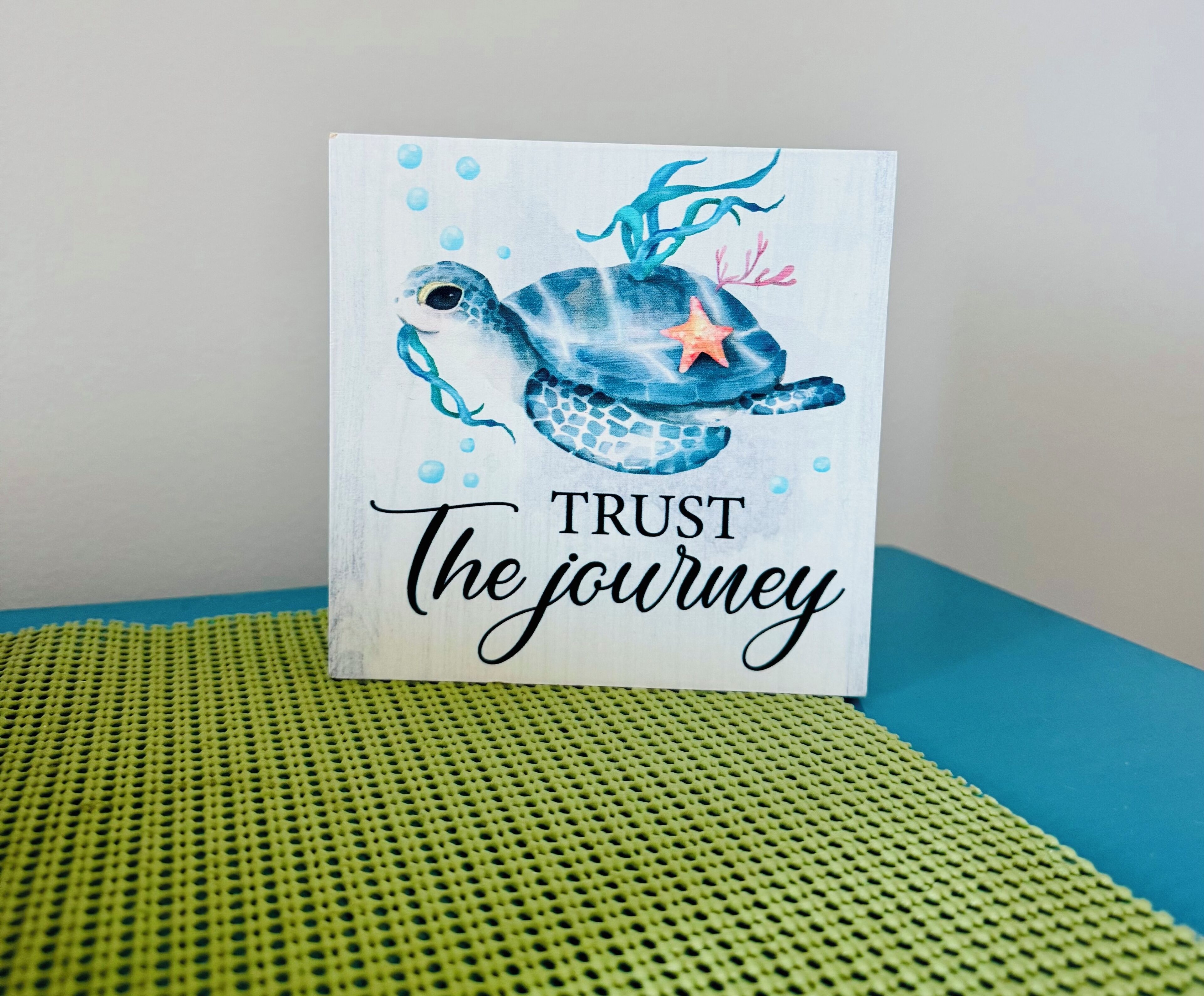 A card with a turtle illustration and the text "TRUST The journey".