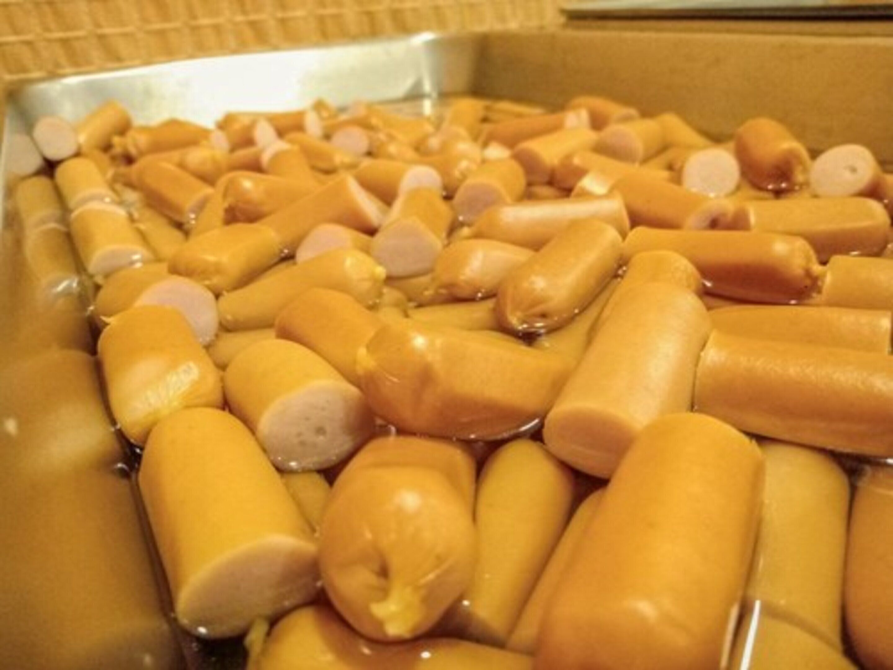 A box filled with various cylindrical objects, likely food items, in a kitchen setting.
