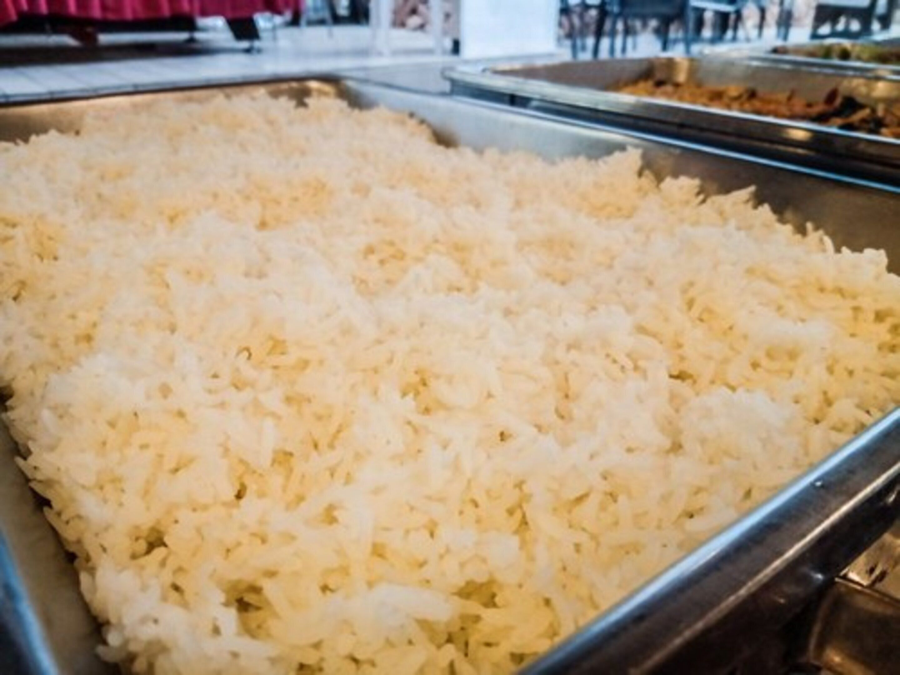 A buffet table filled with white rice.