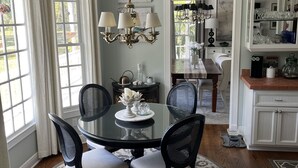A dining area with a round table, four chairs, a chandelier, and a view of the kitchen. - Spacious Countryside Home Near Sanford - 3BR,2.5BA (Sanford)