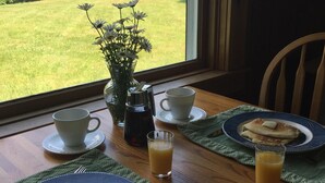 A breakfast table with pancakes, a cup of coffee, and a glass of orange juice. - Fall Colors Await-Book Early Escape to Crisp Mountain Air-Family Fun Pets ok (Franconia)