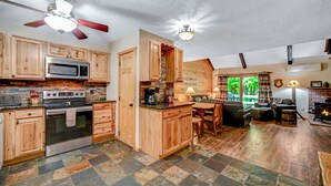 A kitchen with wooden cabinets, a microwave, stove, and a ceiling fan. - Camelback,Aquatopia/Camelbeach Waterparks,Pool,Tennis,Paintball,Zip-Line,Jacuzzi (Tannersville)